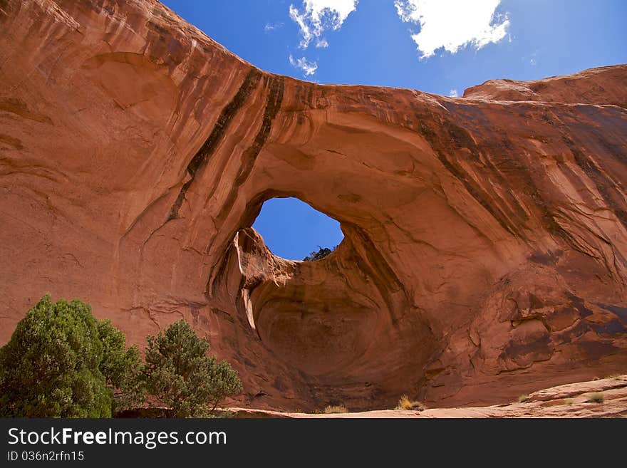 Bowtie Arch, a pothole arch formed when a pothole broke through from the top of the cliff. Corona Arch Trail, Moab, just outside Arches National Park.