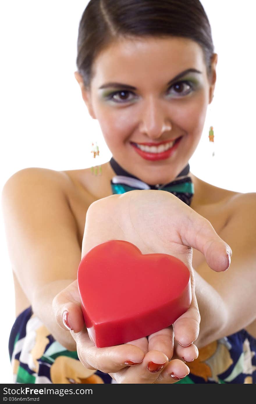 Wide angle of a beautiful woman holding a big red heart