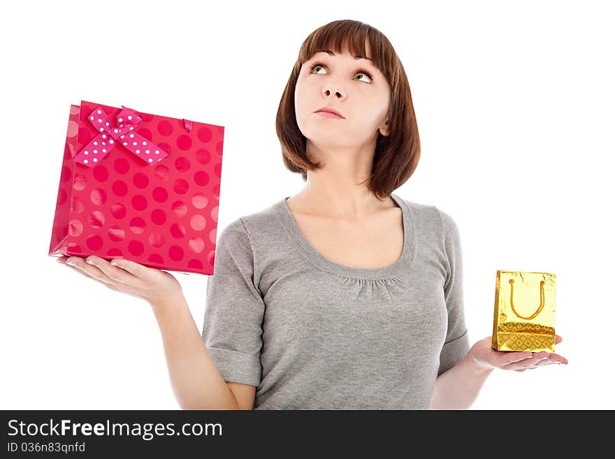 Young woman with shopping bags thinking what is better - small bag or big bag. Isolated on white. Young woman with shopping bags thinking what is better - small bag or big bag. Isolated on white