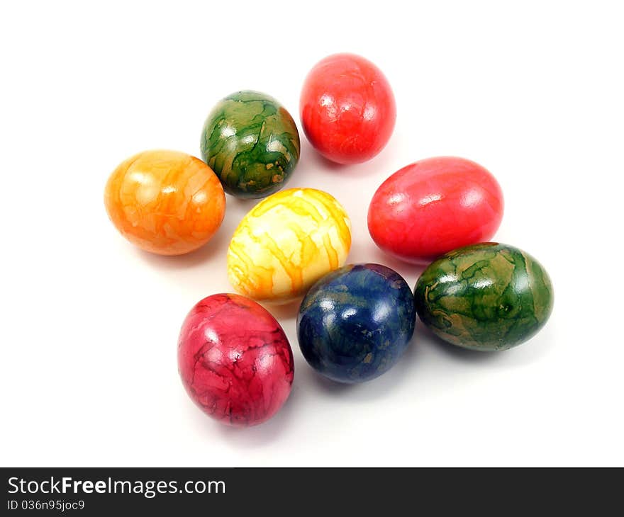 A selection of shiny painted easter eggs on a white background