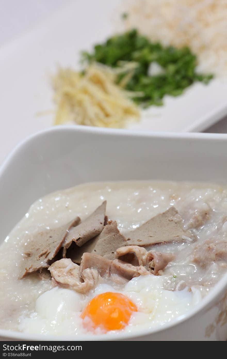 Rice porridge, or jook in white bowl