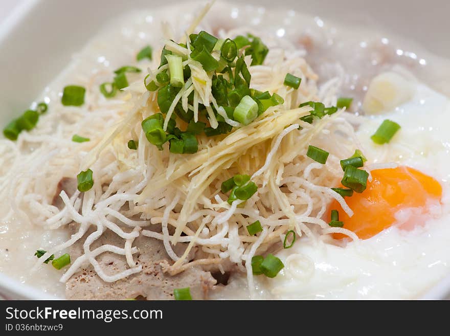 Rice porridge, or jook in white bowl