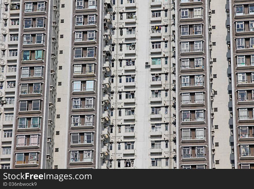 It is the private residential building in downtown of Hong Kong. It is in grey and white colour. It is the private residential building in downtown of Hong Kong. It is in grey and white colour.