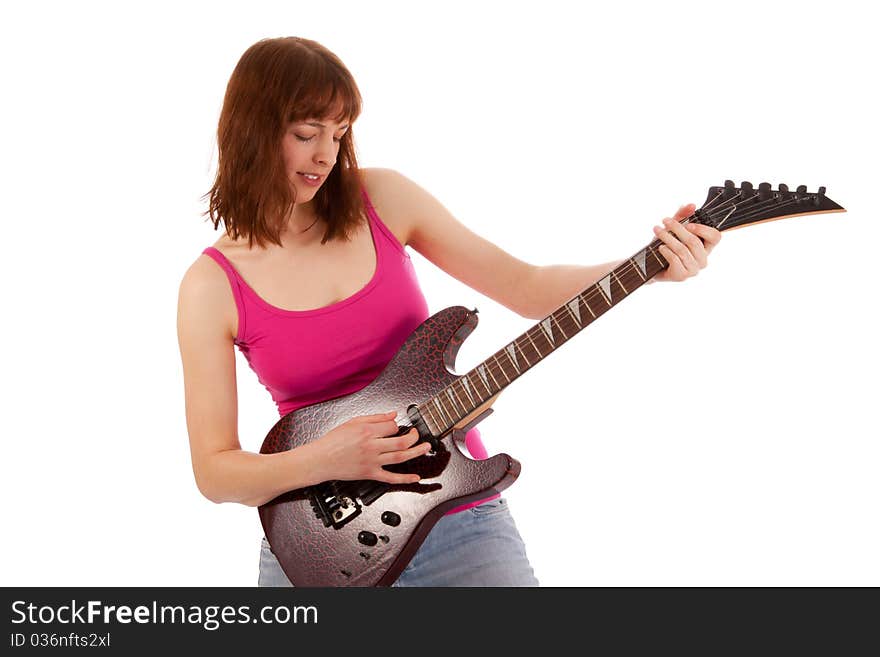 A beautiful young woman is playing a guitar. A beautiful young woman is playing a guitar