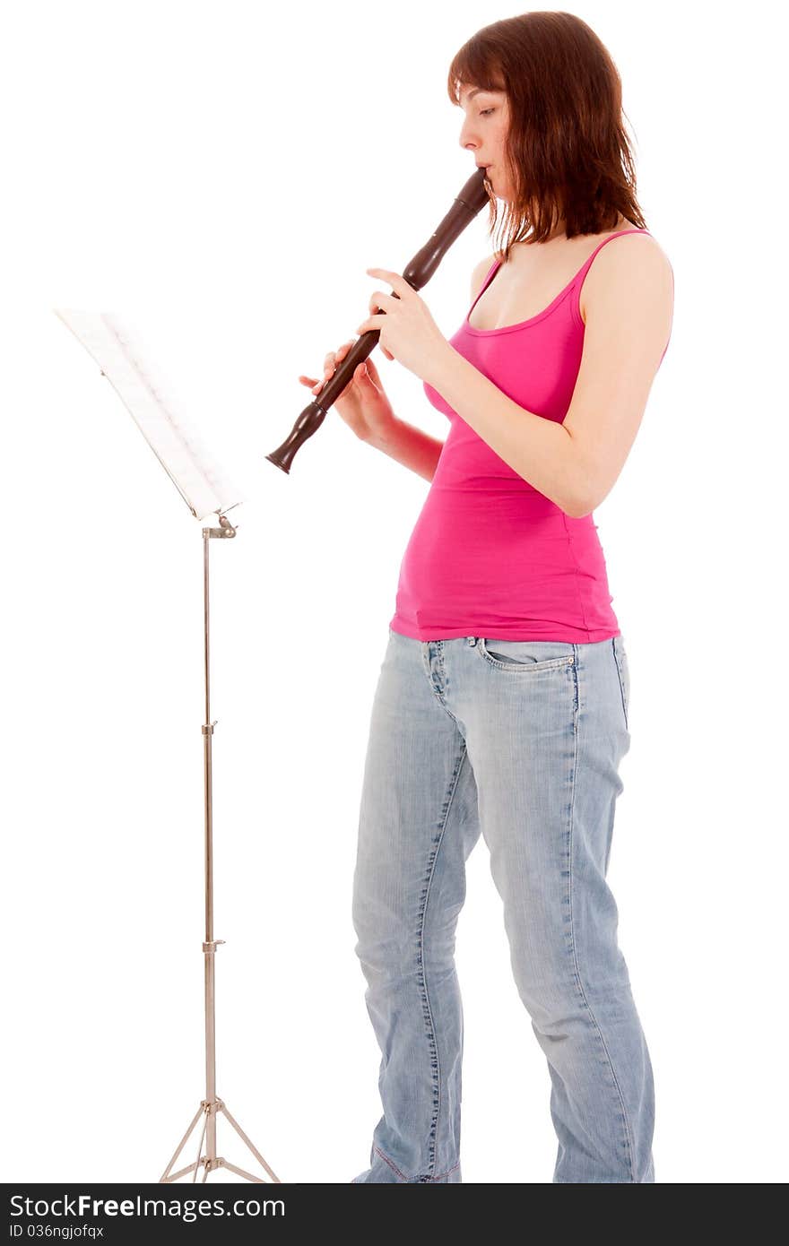 A beautiful young woman is playing a whistle. A beautiful young woman is playing a whistle