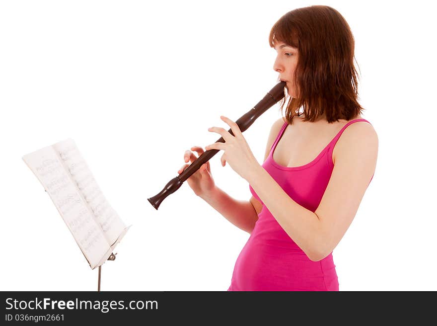 A beautiful young woman is playing a whistle. A beautiful young woman is playing a whistle