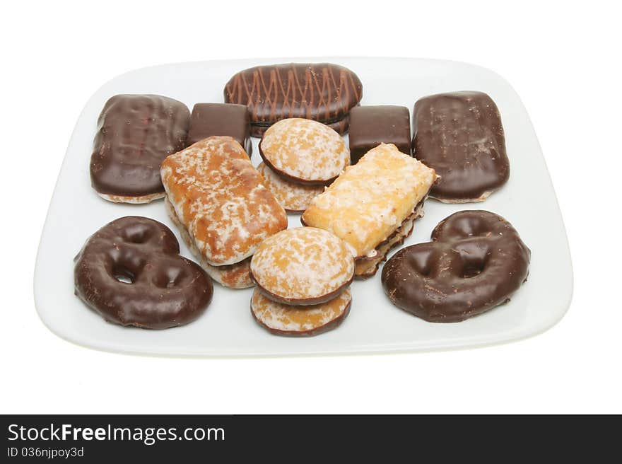 Selection of Lebkuchen continental biscuits on a plate isolated against white. Selection of Lebkuchen continental biscuits on a plate isolated against white