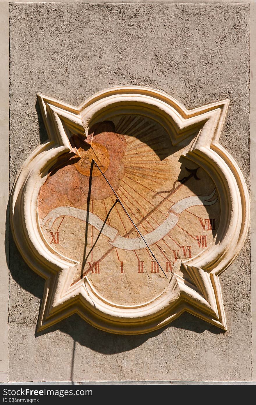 An old-fashioned sun dial on a wall. An old-fashioned sun dial on a wall