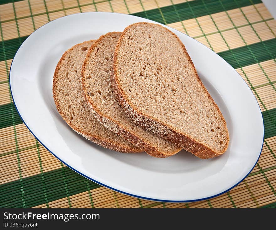 Three slices of brown bread on a plate