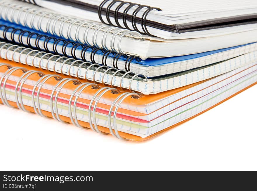 Pile of checked notebook isolated on white background