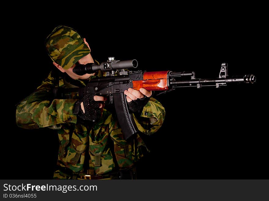 Soldier in uniform with rifle, isolated on black background