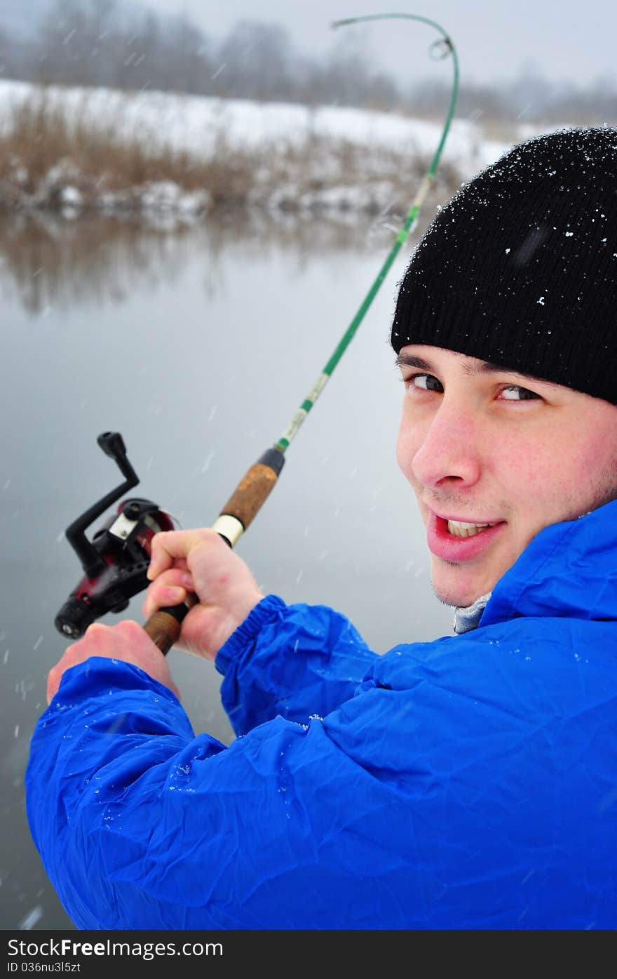 Portrait of an excited man fishing in winter time. Portrait of an excited man fishing in winter time