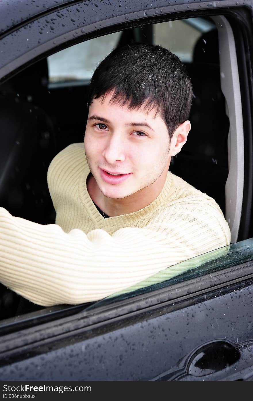 Happy Young Man Smiling From His Car