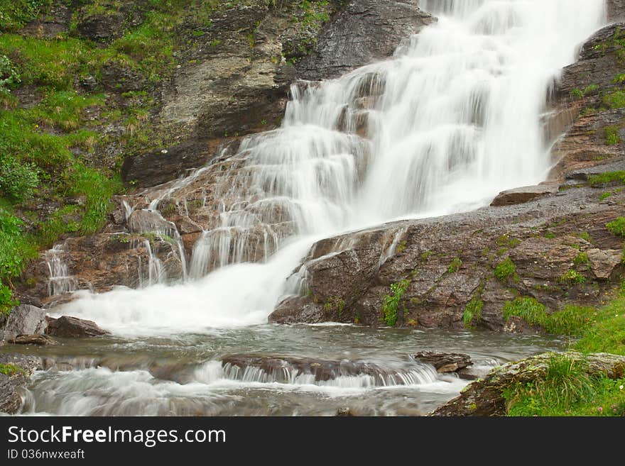 Waterfall in green alps mountains, near Grindelwald. Waterfall in green alps mountains, near Grindelwald