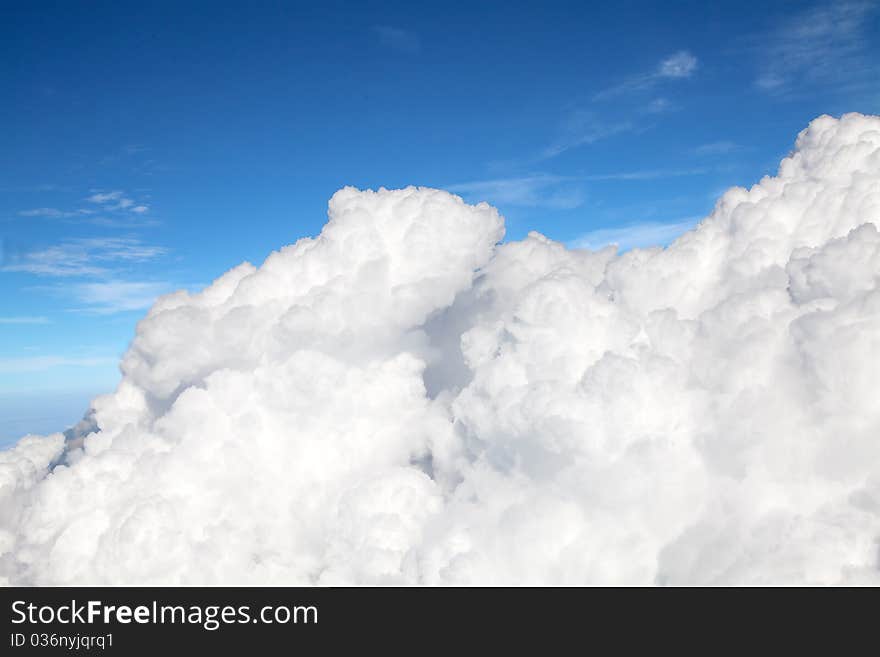 Fluffy clouds shot from airplane window