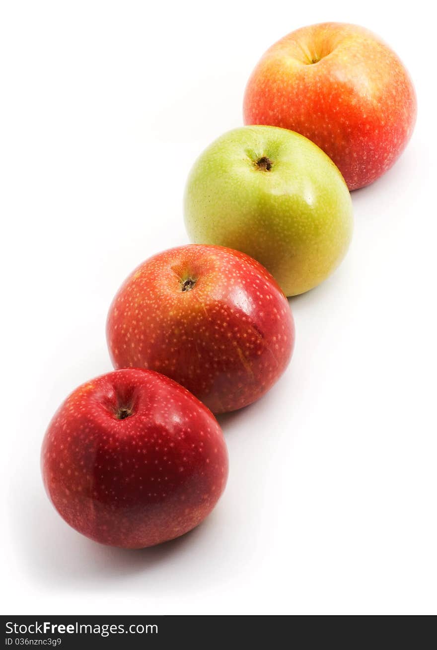 Apples in a row on a diagonal, white background