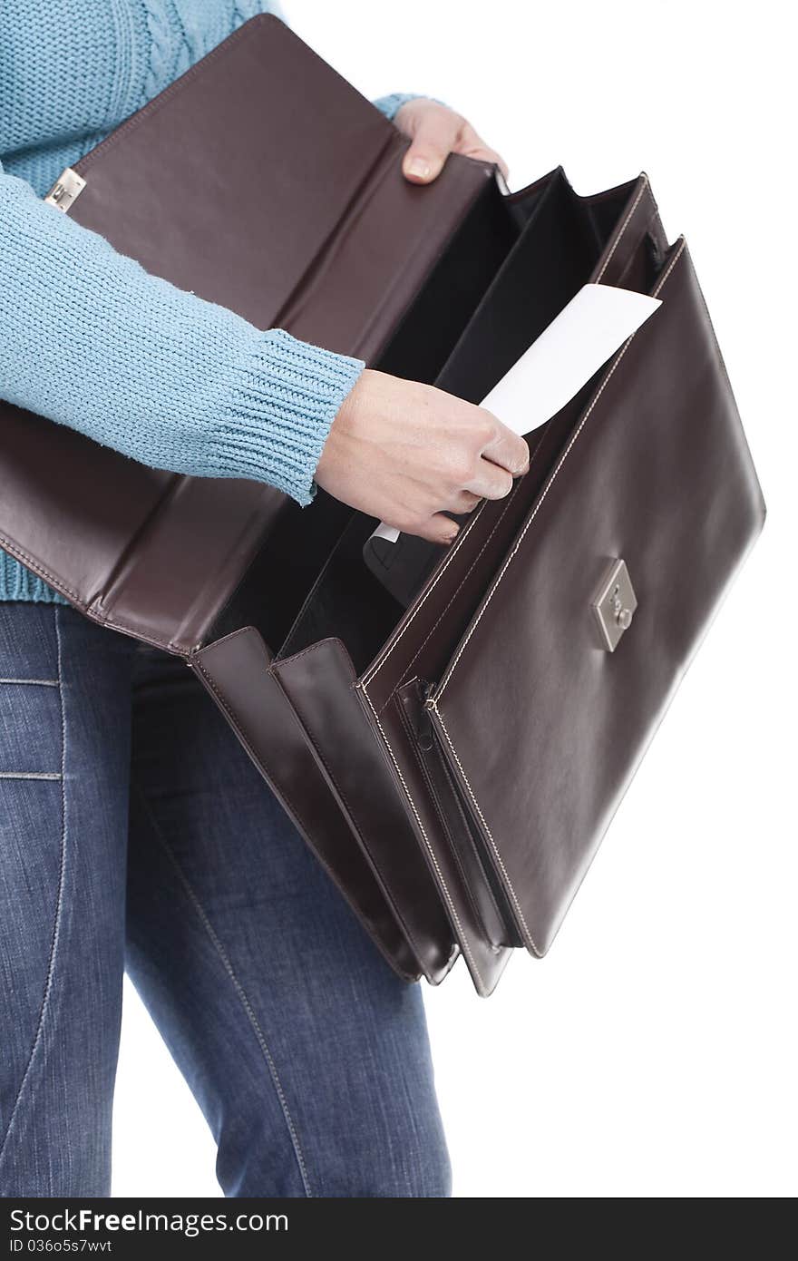 A business woman holding a briefcase and taking some documents out