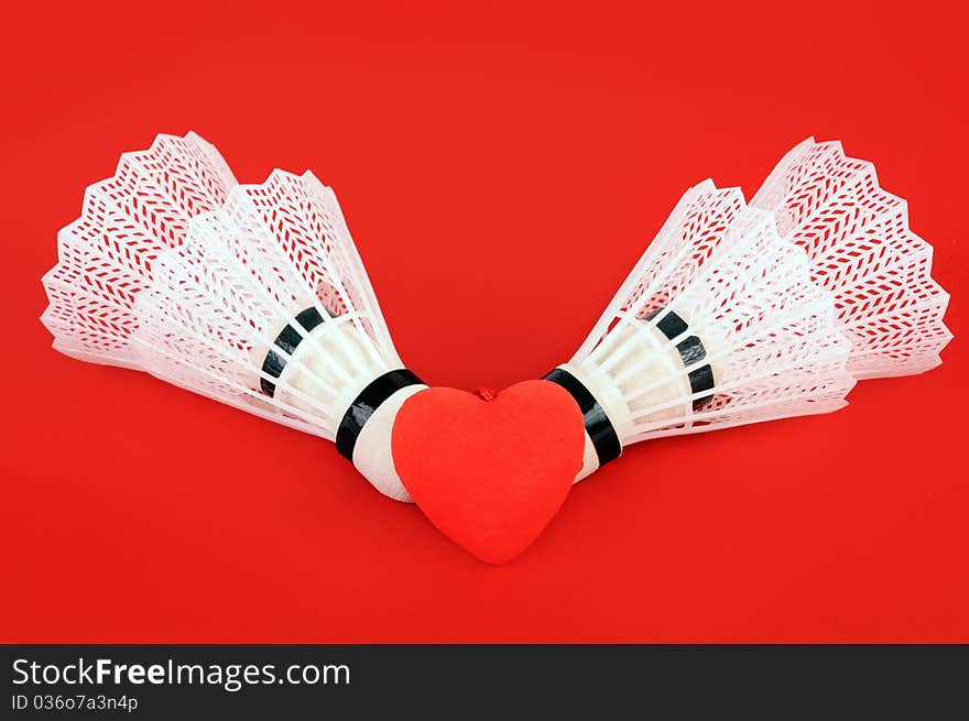 Four flounces for game in badminton on a red background. Four flounces for game in badminton on a red background