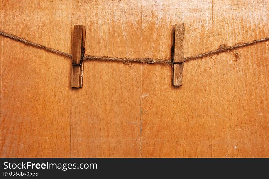 Pins on rope, wooden background