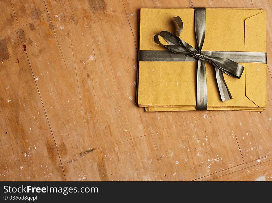 Vintage envelopes with a bow on a wooden background