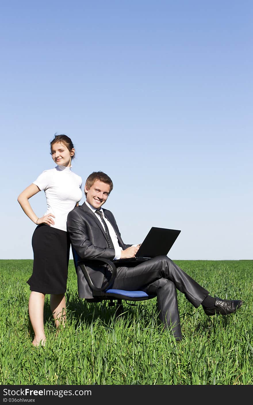 Young, confident businessmen working on laptop