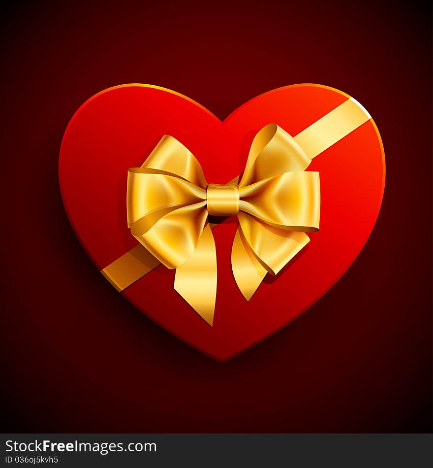 Red heart shape gift with golden bow