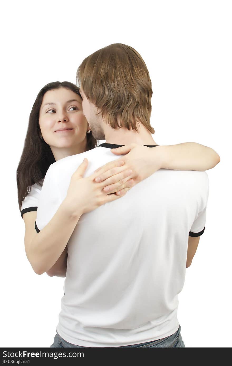 Beautiful young girl hugging her young man on a white background. Beautiful young girl hugging her young man on a white background