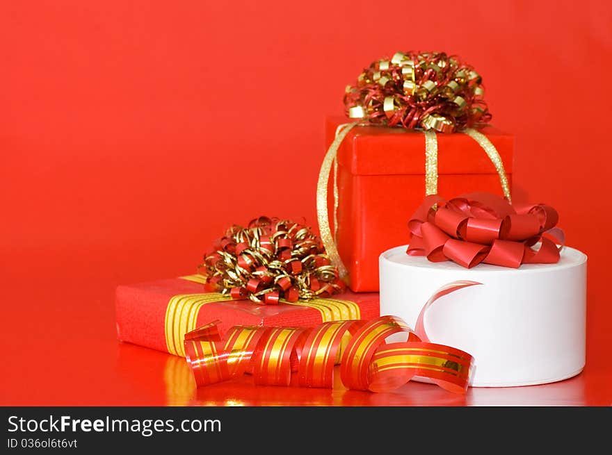 Box with a gift on a red background still life