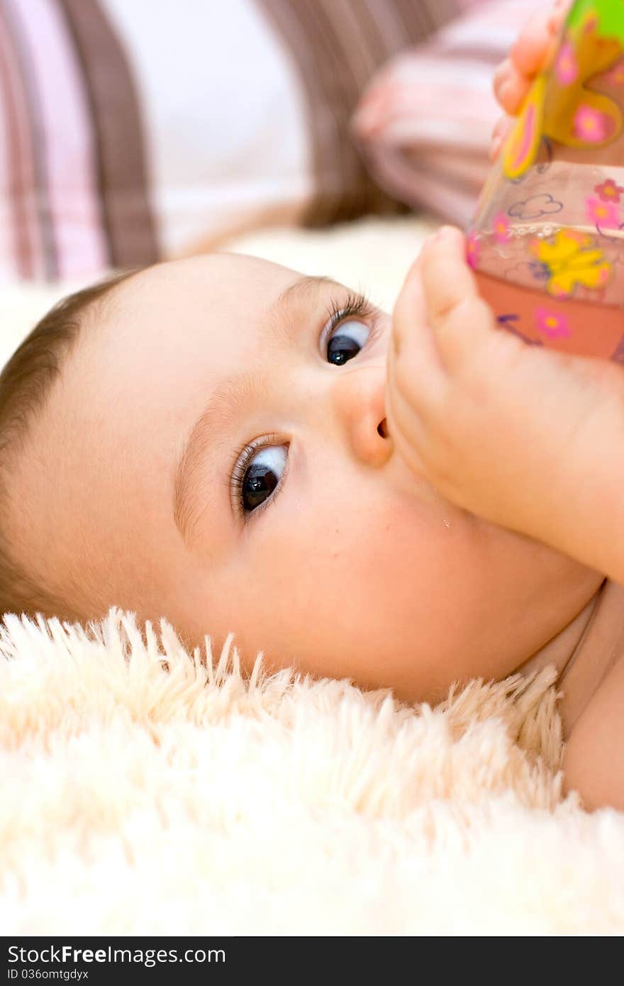 Little Caucasian Boy Drinking From The Bottle