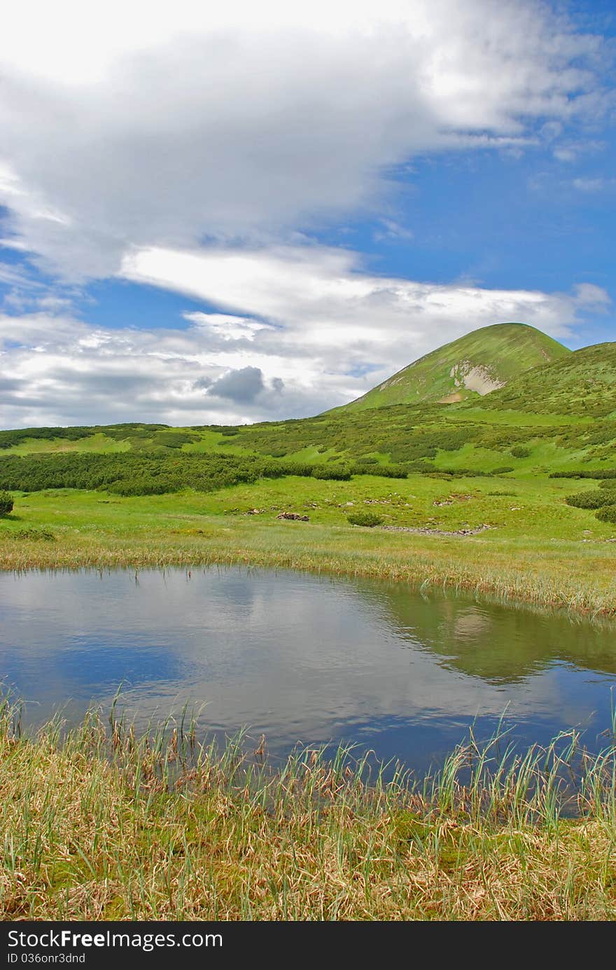 Mountain lake in a summer bright landscape. Mountain lake in a summer bright landscape