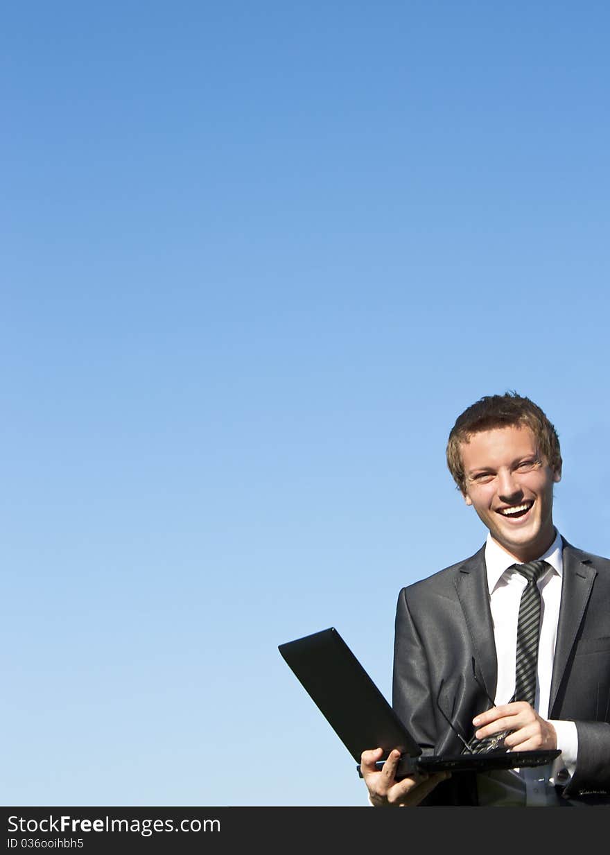 Young Business Man With A Laptop On Street