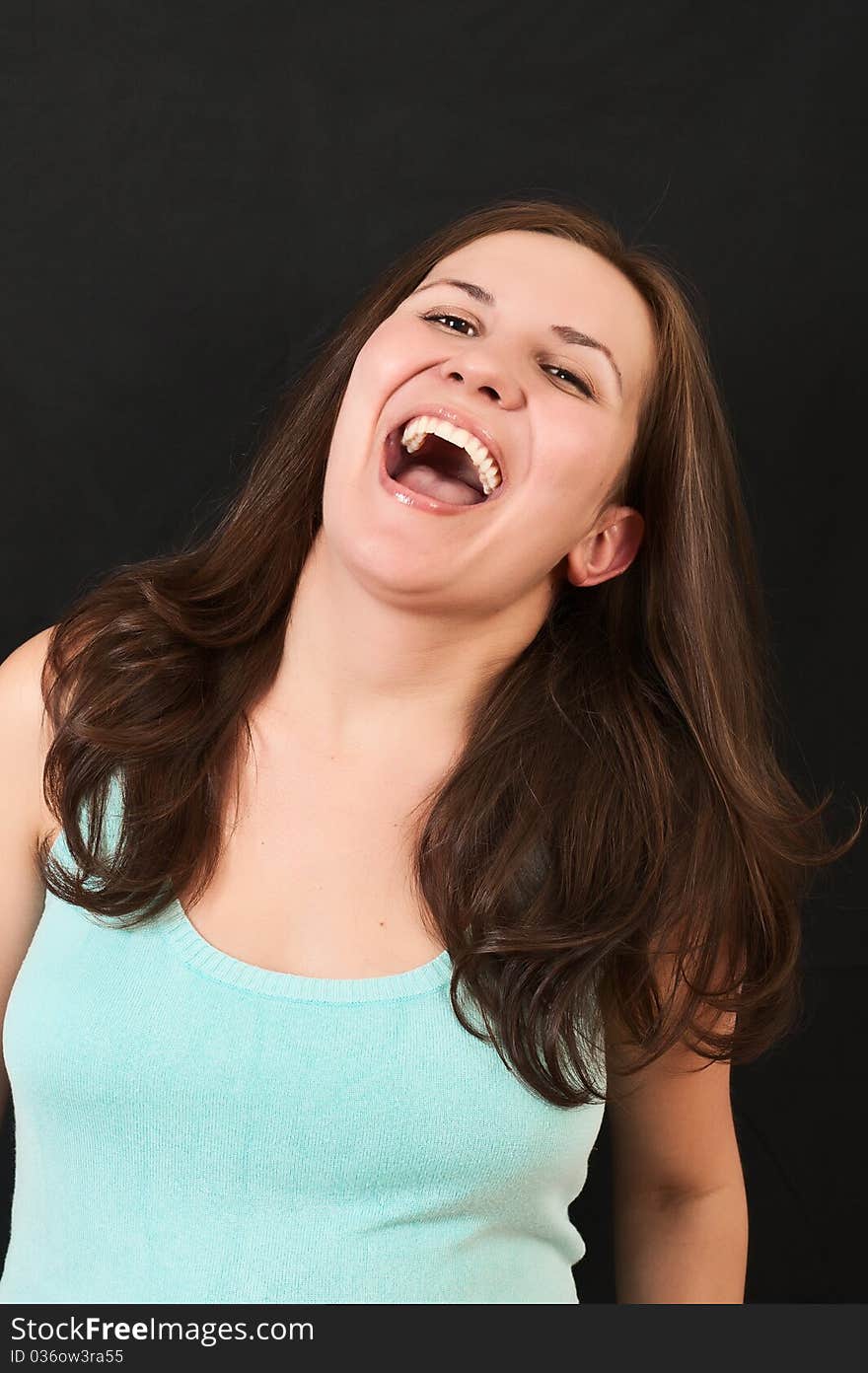 Portrait of a beautiful young girl on a black background