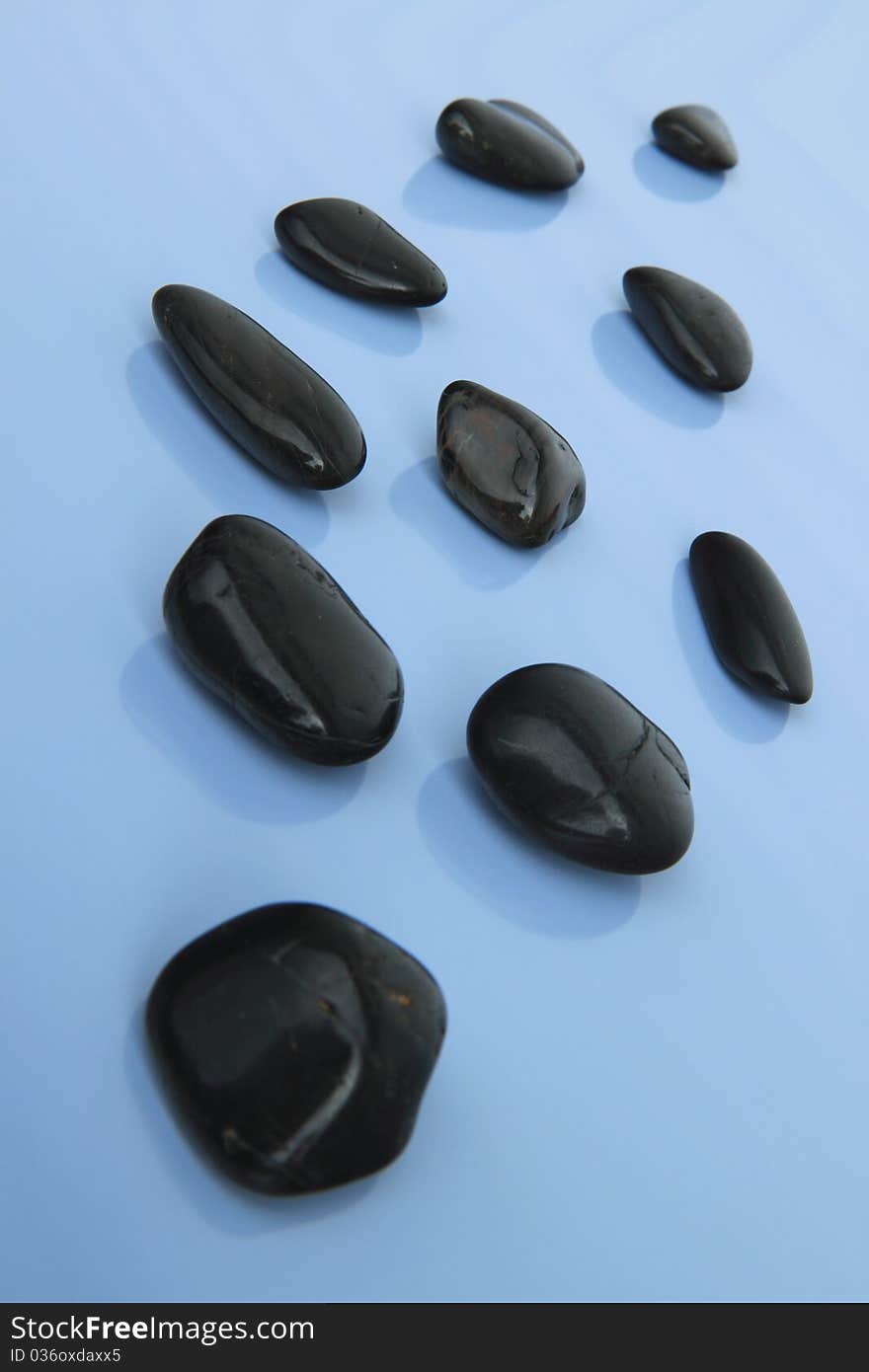 Spa stones on the blue background