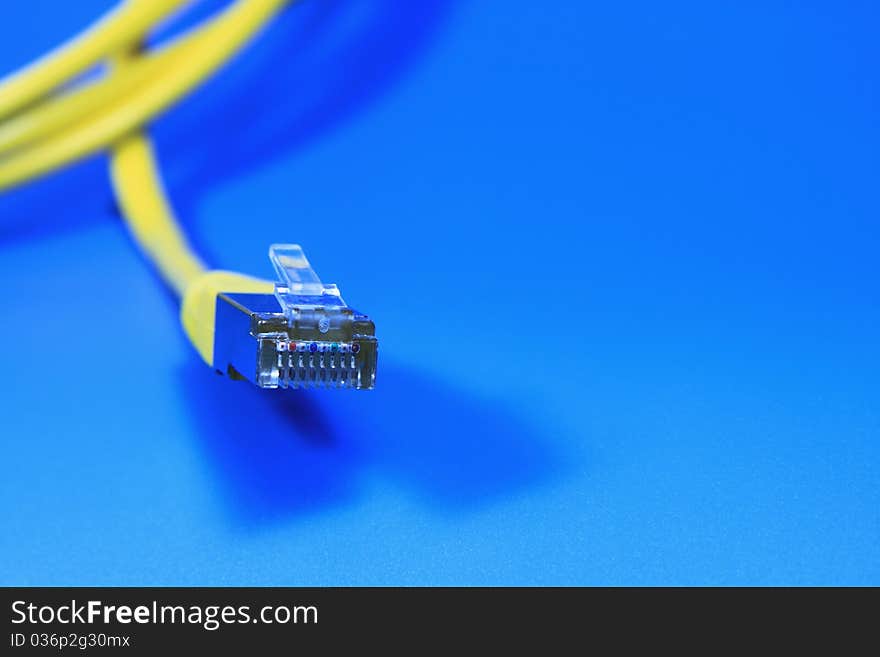 Yellow network cable on a blue background