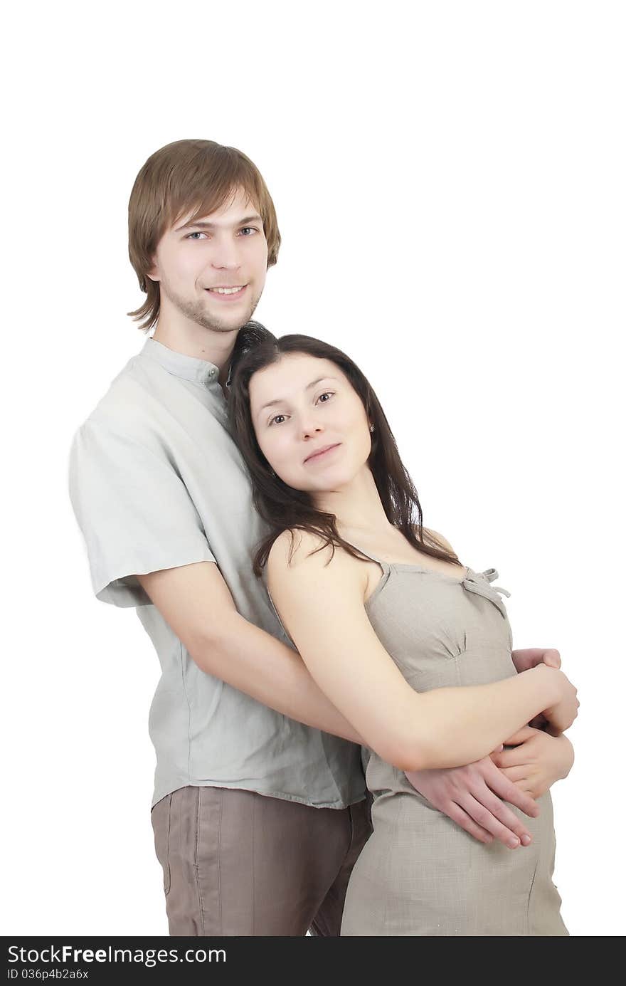 Beautiful young girl hugging her young man on a white background. Beautiful young girl hugging her young man on a white background