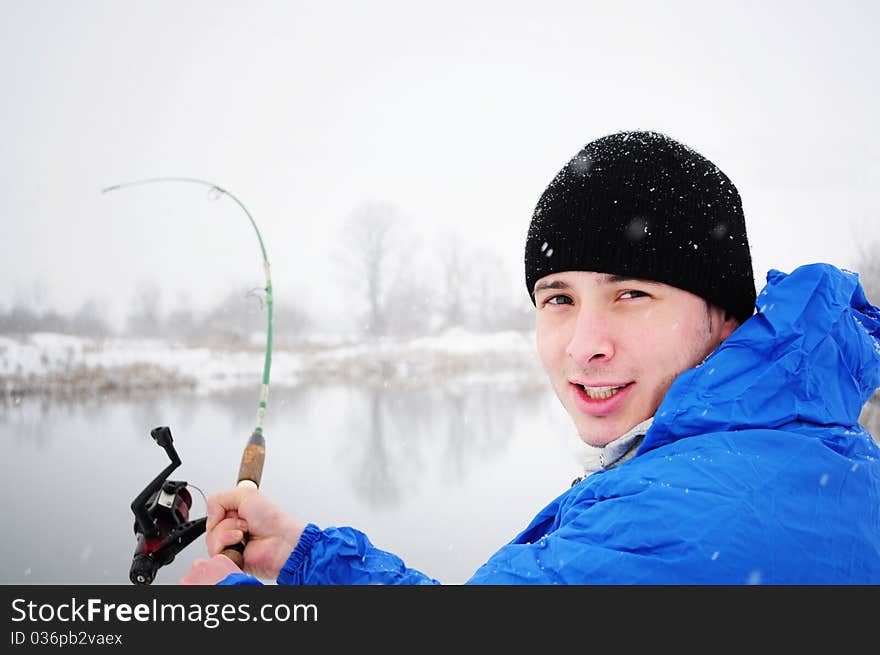 Portrait of an excited man fishing in winter time. Portrait of an excited man fishing in winter time