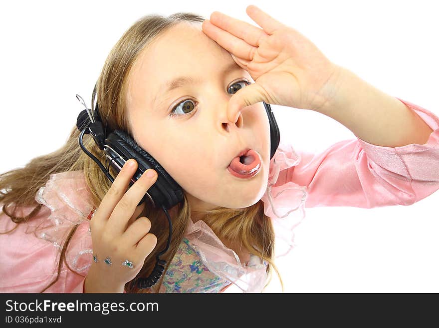 Little girl listening to music and a real funny face. Little girl listening to music and a real funny face