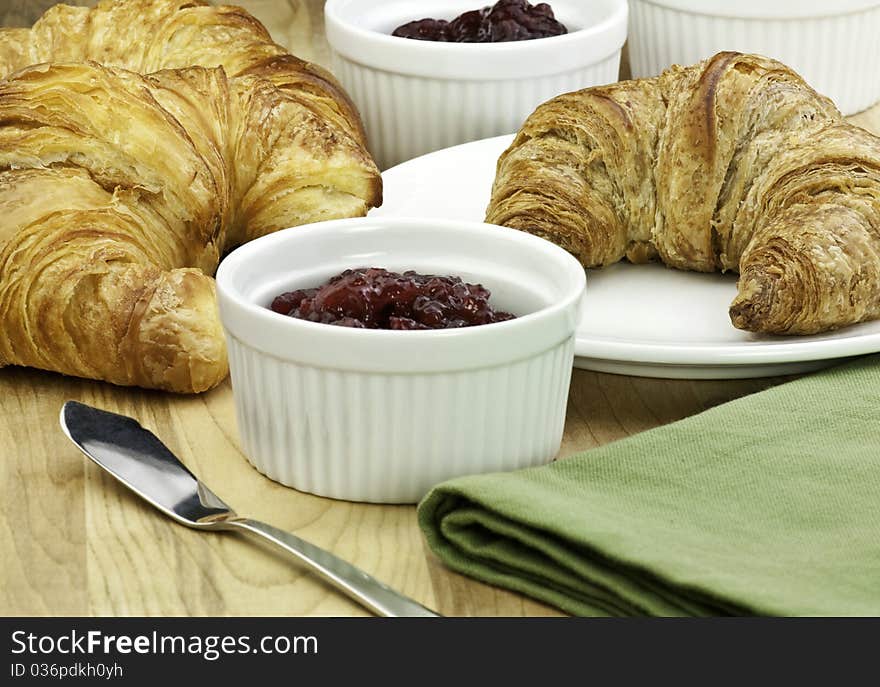 Fresh baked croissants and fruit jam. Fresh baked croissants and fruit jam