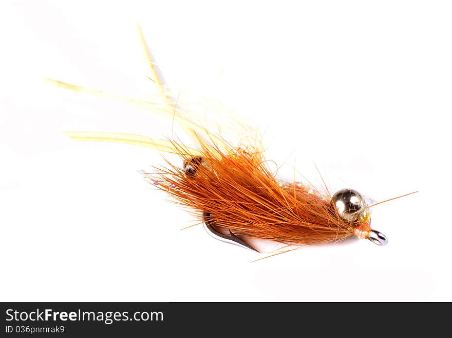 Orange bead head salt water fly isolated on a white background. Orange bead head salt water fly isolated on a white background