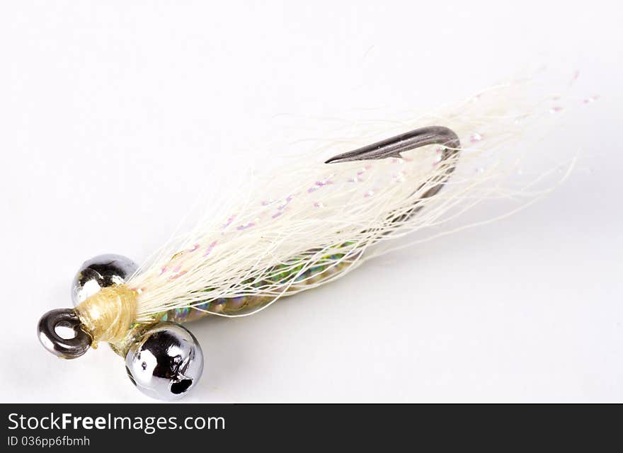 White bead head salt water fly isolated on a white background. White bead head salt water fly isolated on a white background