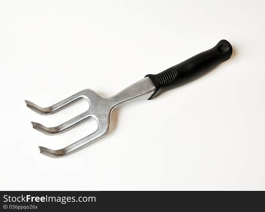 Stainless steel garden fork isolated on white background. Stainless steel garden fork isolated on white background