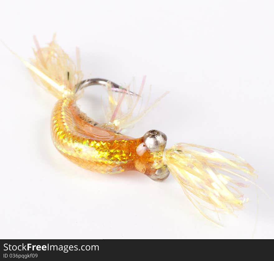 Yellow gold bead head salt water fly isolated on a white background. Yellow gold bead head salt water fly isolated on a white background
