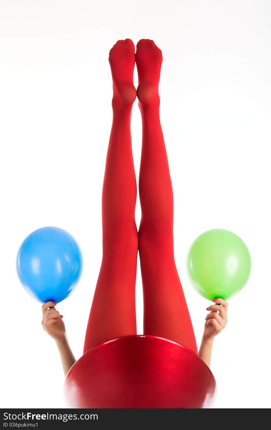 Female feet in red stockings with balloons isolated in white