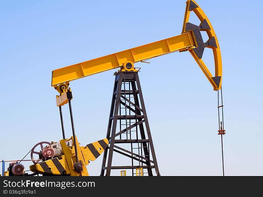 Close-up of oil pump jacks.A pumpjack against blue sky