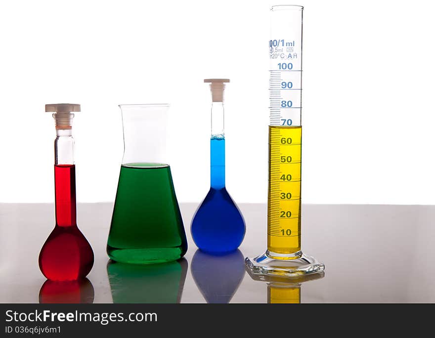 Labolatory glassware with colorful fluids isolated