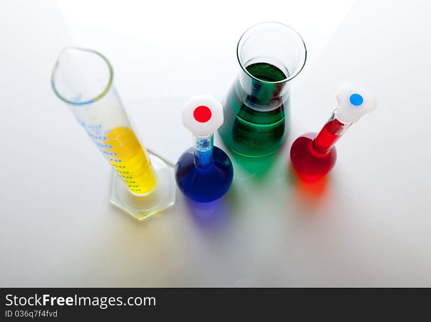 Labolatory glassware with colorful fluids isolated