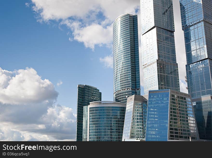 Many scyscrapers of Moscow city under blue sky with clouds