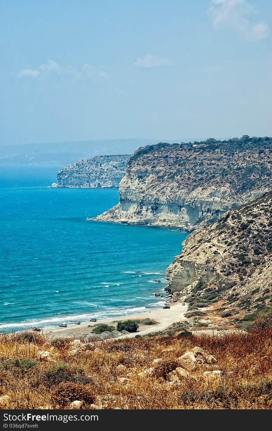 Kourion coast with blue sea and sky with clouds.