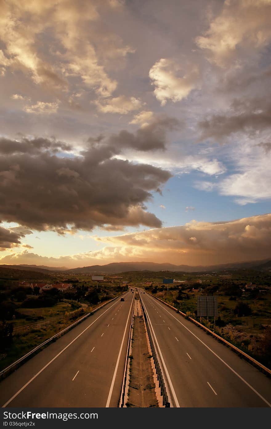 Cloudy sunset over highway