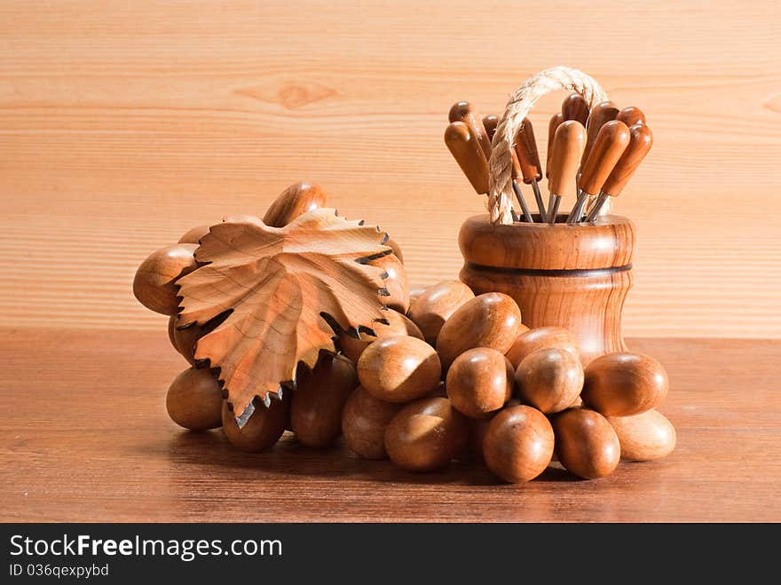 Fondue forks and a branch of grapes from a tree. Fondue forks and a branch of grapes from a tree